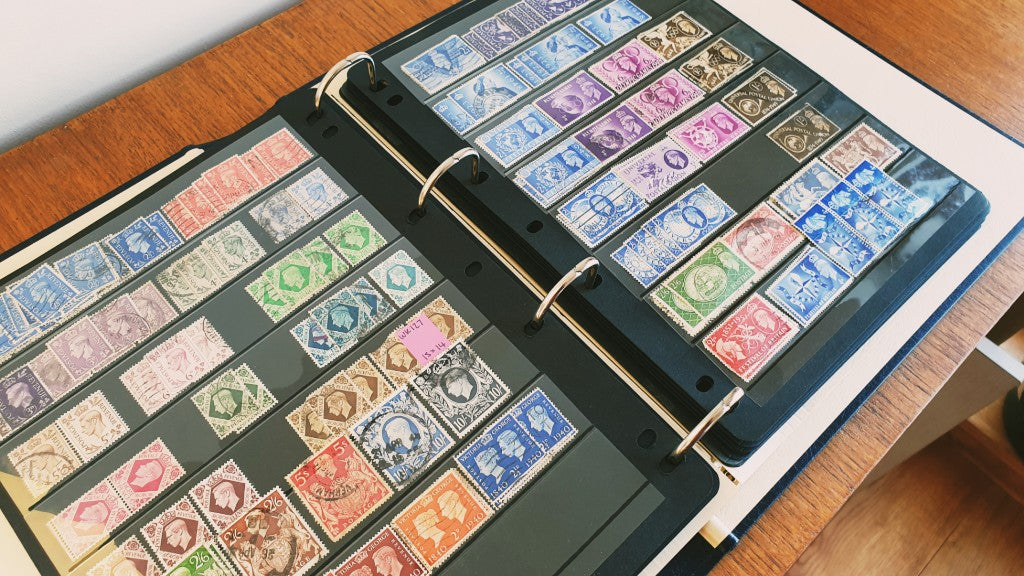 photo of GB postage stamps laid out in black album pages