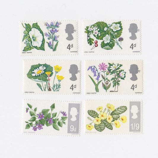 Set of six vintage postage stamps with floral designs on a white background