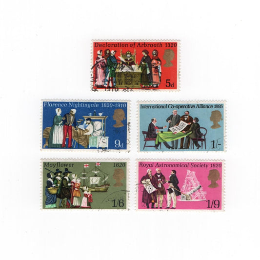 Set of five vintage stamps with historical scenes on a white background