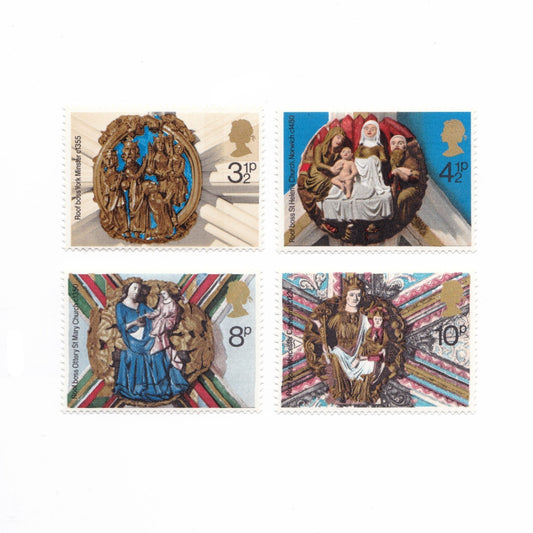 Four vintage stamps featuring religious scenes with intricate designs and portraits.