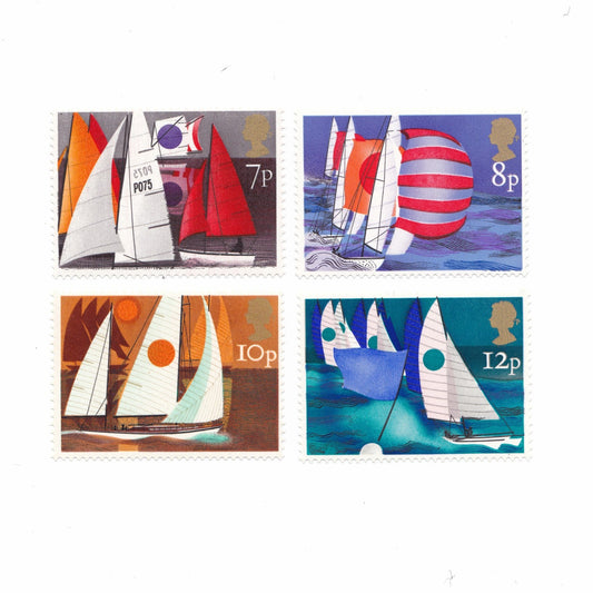 Bold images of sail boats on postage stamps on a white background