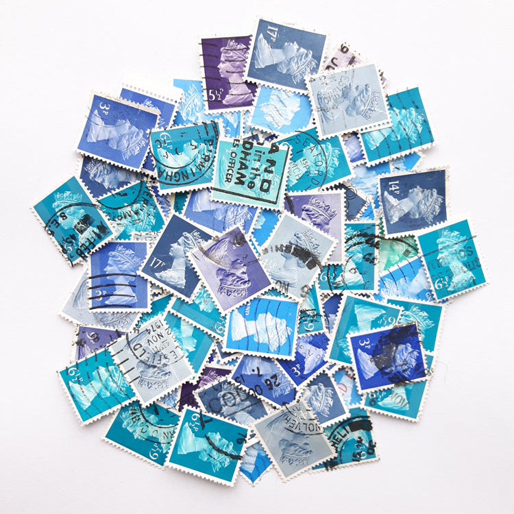 Collection of blue and purple postage stamps on a white background